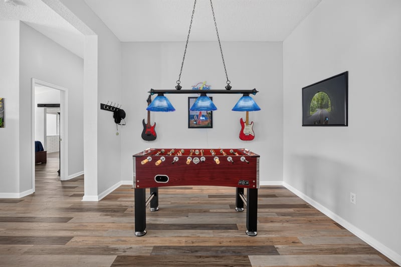 Game room with wall-mounted guitars and wood flooring at 2065 Creekmont Dr