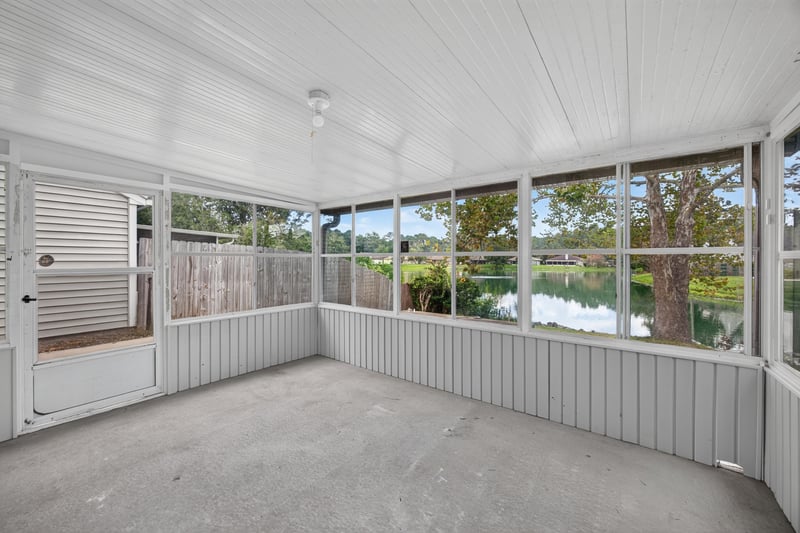 Sunroom with white paneled walls and windows at 8047 Mactavish Way E, Jacksonville, FL 32244