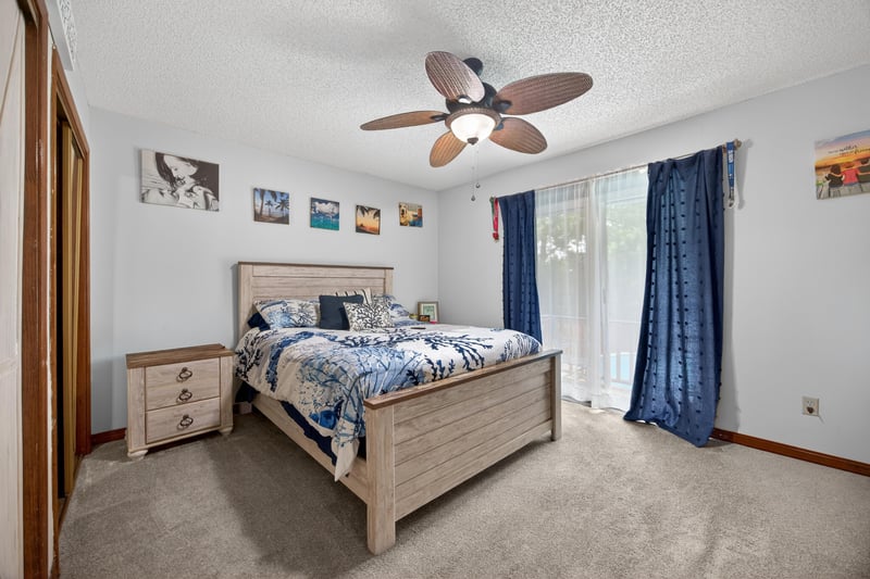 Bedroom with ceiling fan and wood-look flooring at 981 Marble Ridge Dr, Orange Park, FL 32065