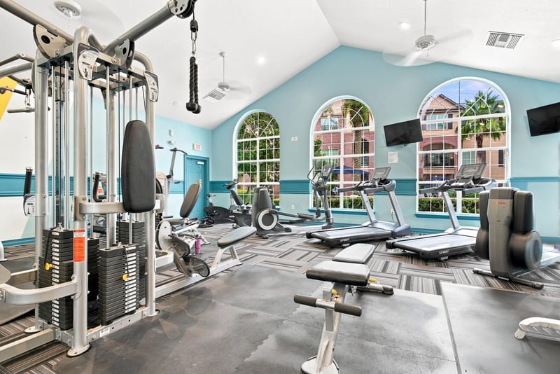 Community fitness room with exercise equipment in Reserve at Point Meadows