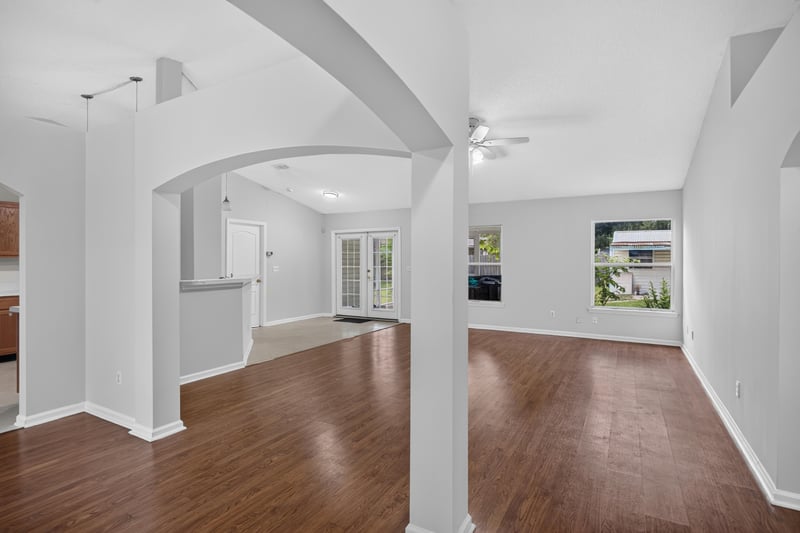 Entry hallway with wood floors and arched opening at 9691 Nelson Forks Dr, Jacksonville, FL 32222