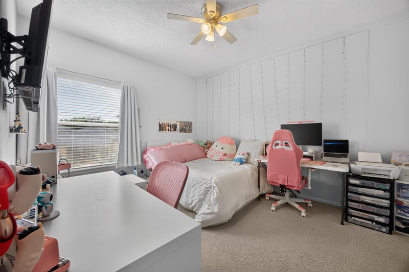 Bedroom with desk and pink decor at 2875 Pebblewood Ln, Orange Park, FL 32065