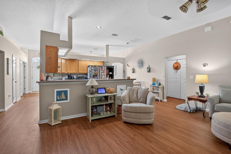 Wide view of kitchen island and open living room at 13514 Las Brisas Way N, Jacksonville, FL