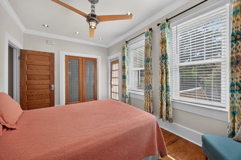 Bedroom with wood French doors and a ceiling fan at 1555 Belmonte Ave, Jacksonville, FL 32207