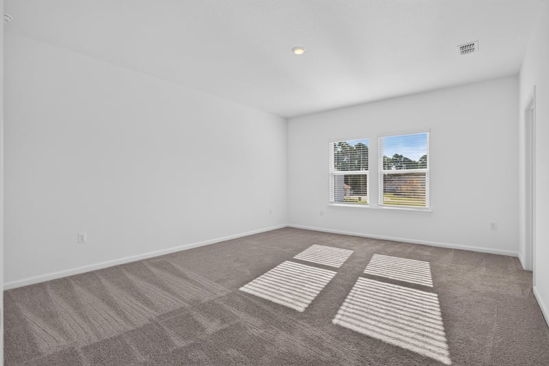 Empty carpeted bedroom with window at 269 Bluegrass Wy, St. Augustine, FL 32092