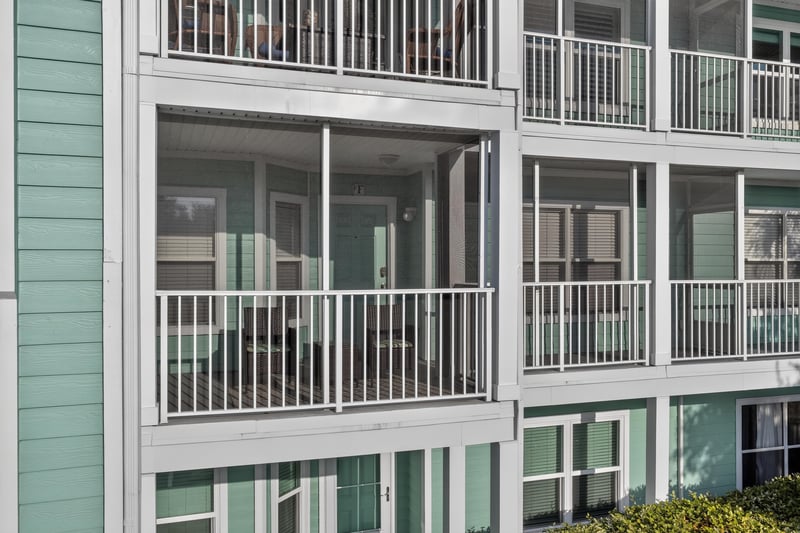 Close view of stacked screened balconies on the building at 206 16th St, St. Augustine, FL 32080