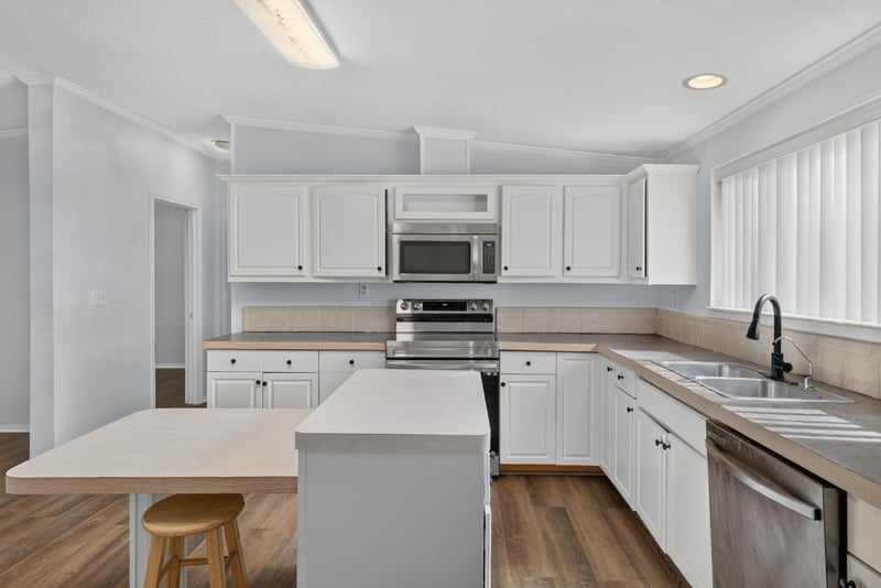 Kitchen with range, refrigerator and island seating at 3215 Robin Ln, Middleburg, FL