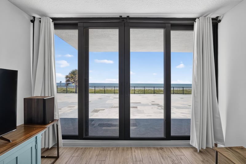 Sliding glass doors opening to balcony and beach view at 601 1st St S, Jacksonville Beach