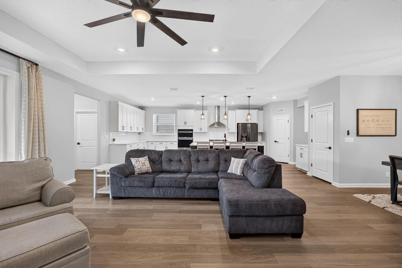 Living room with sectional sofa and open kitchen view at 2354 Jennings Farm Dr, Middleburg, FL 32068