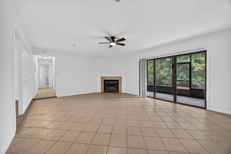Living room with tile floor and fireplace at 3801 Crown Point Rd unit 2061, Jacksonville, FL 32257
