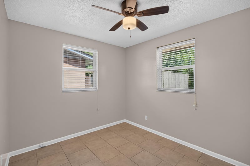Bedroom with two windows and ceiling fan at 8067 Parental Cir, Jacksonville, FL 32216