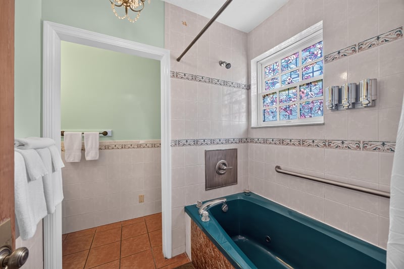 Bathroom with a freestanding tub and tile surround at 115 Cordova St, St. Augustine, FL