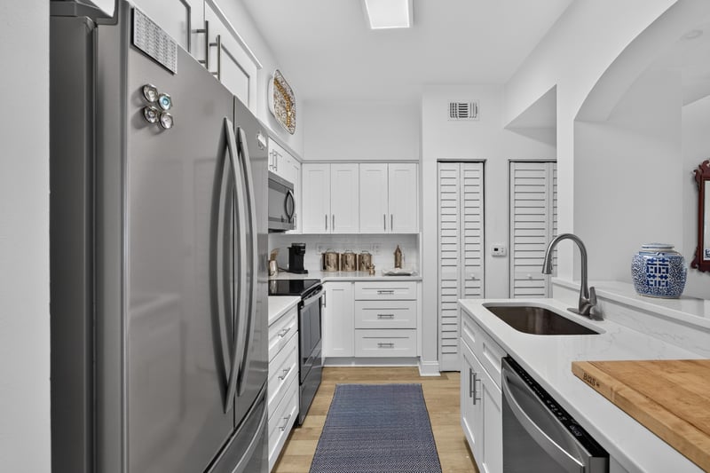 Kitchen with stainless refrigerator and white cabinets at 10435 Mid Town Pkwy unit 135, Jacksonville, FL 32246