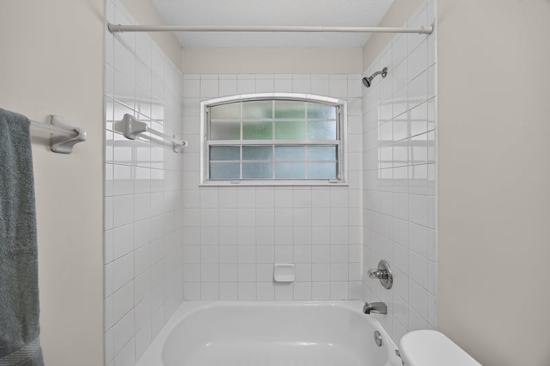 Bathroom tub and shower with window at 605 N Covered Bridge Rd, Jacksonville, FL