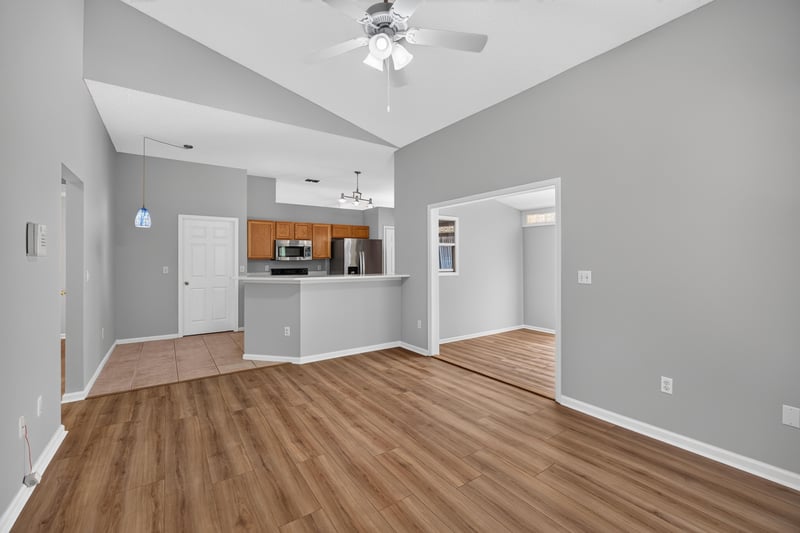 Living room open to kitchen with wood floor at 9256 Dale View Ln W, Jacksonville, FL 32225