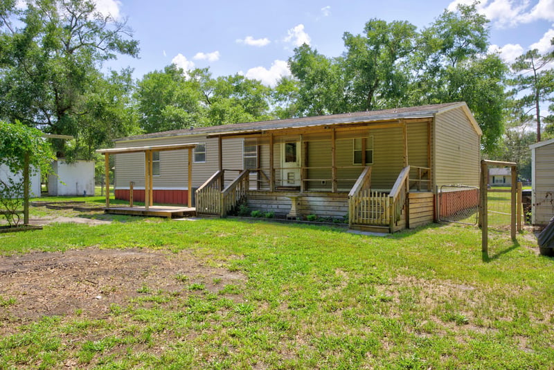 Rear exterior with covered porch and deck at 2549 Snapdragon Ave, Middleburg, FL 32068