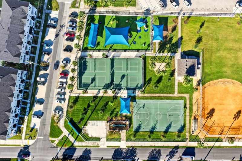 Aerial view of community tennis courts and pool area in Jacksonville Beach, FL