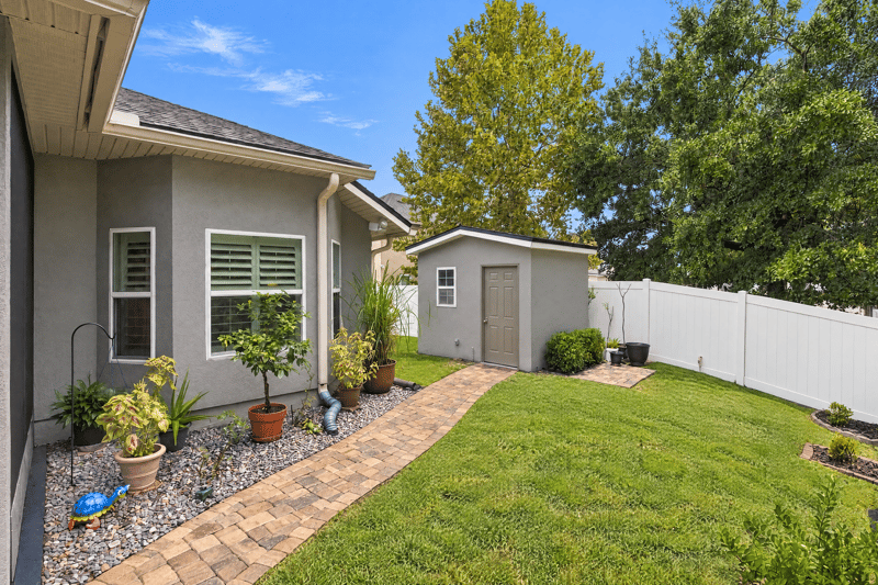 Backyard with house exterior and storage shed at 10923 Black Diamond Ct, Jacksonville, FL