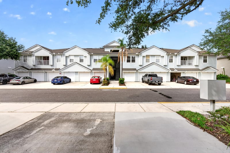 Front exterior with covered parking and entry walkway at 7047 Deer Lodge Cir, Jacksonville