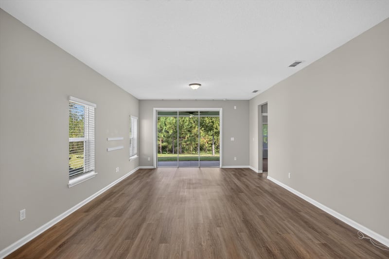 Living room with wood floor and window at 75875 Saffron Ln, Yulee, FL 32097