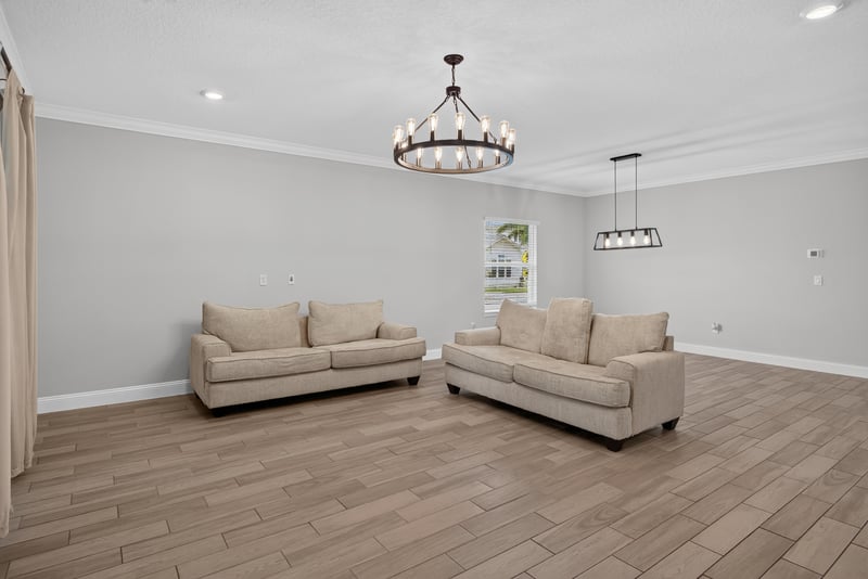 Living room seating with two sofas and a chandelier at 91 Tilloo Ct, St. Johns, FL