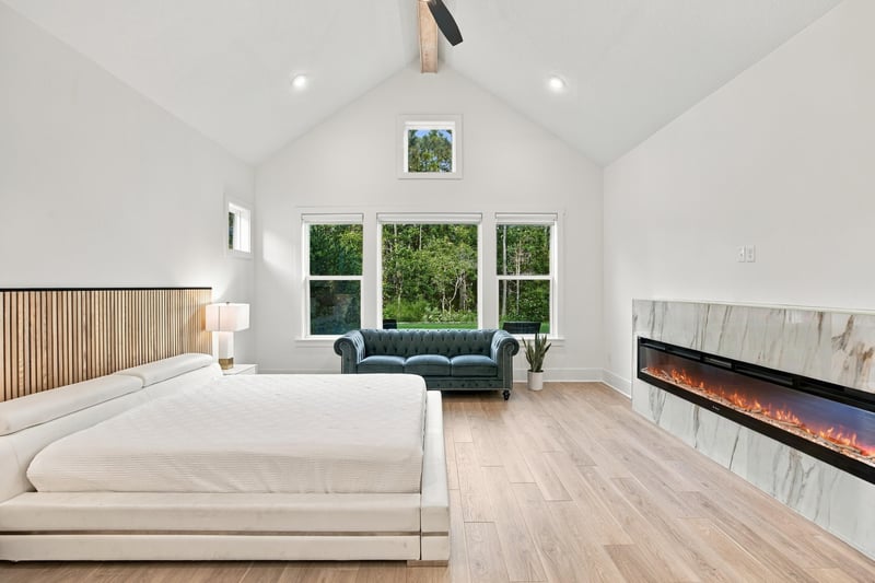 Primary bedroom with fireplace and bed at 907 Seagrove Dr, Ponte Vedra Beach, FL 32081