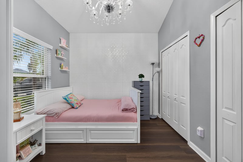 Bedroom with pink bedding and white furniture at 538 Porta Rosa Circle, St. Augustine, FL 32092