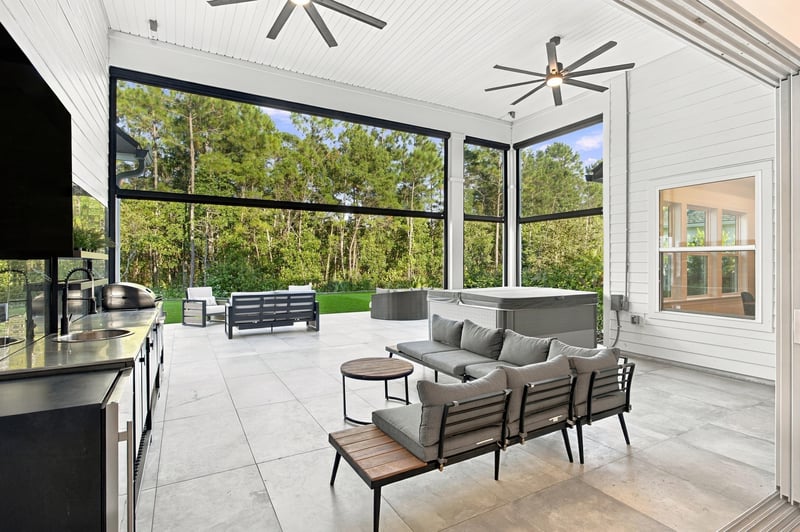 Covered patio outdoor kitchen with bar seating at 907 Seagrove Dr, Ponte Vedra Beach, FL 32081