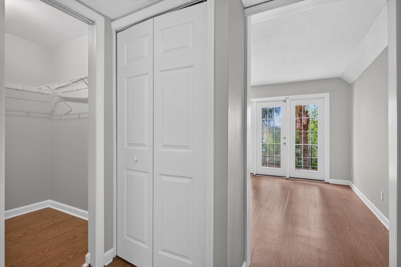Hallway with closet doors and window at 3866 Campenero Ct unit 6, Jacksonville, FL 32217