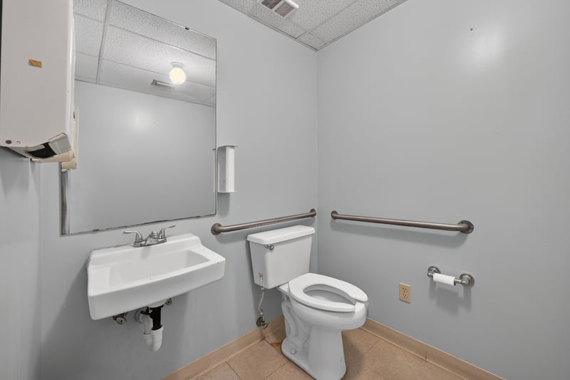 Bathroom with grab bars, sink and toilet at 1543 Kingsley Ave #19, Orange Park, FL 32073