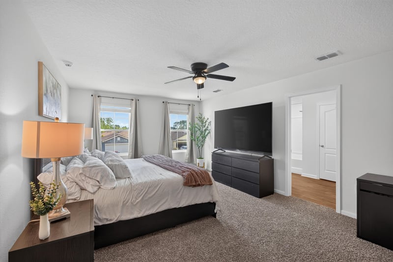 Bedroom with dark dresser and TV at 65255 Frst Glen Ln, Yulee, FL 32097