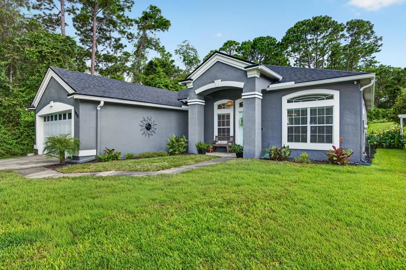 Front exterior close-up showing arched window at 1820 Burgess Hill Dr E, Jacksonville, FL