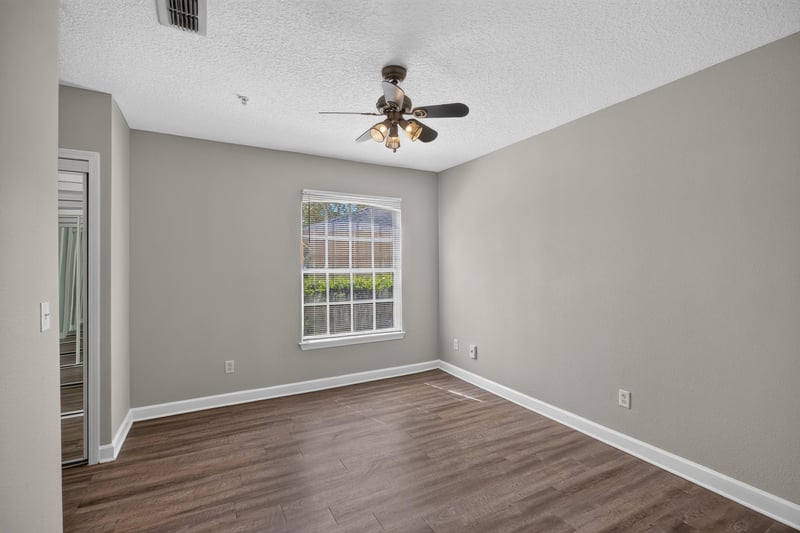 Bedroom with two windows at 1701 The Greens Way 1415, Jacksonville Beach, FL 32250