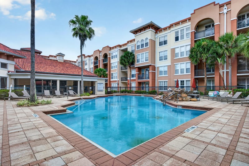 Pool patio with lounge chairs and water feature in Jacksonville, FL