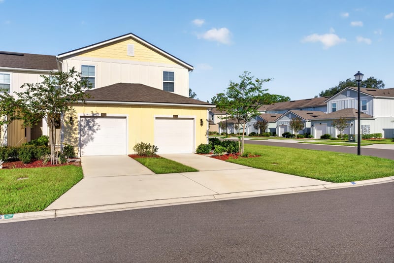 Front exterior from street with yellow siding and garage at 4024 Bay Hawk Ct, Jacksonville, FL