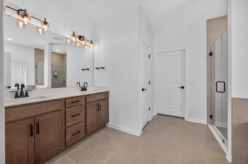 Primary bathroom with wood vanity and dual sinks at 2354 Jennings Farm Dr, Middleburg, FL 32068