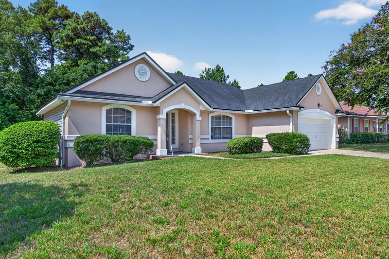 Front exterior view across the lawn at 9256 Dale View Ln W, Jacksonville, FL 32225