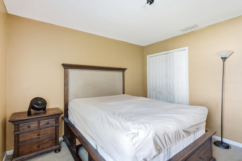 Bedroom with nightstand and floor lamp at 7392 Timber Falls Ct