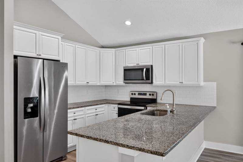 Kitchen with white cabinets and stainless appliances at 2855 N 8th St, St. Augustine, FL 32084