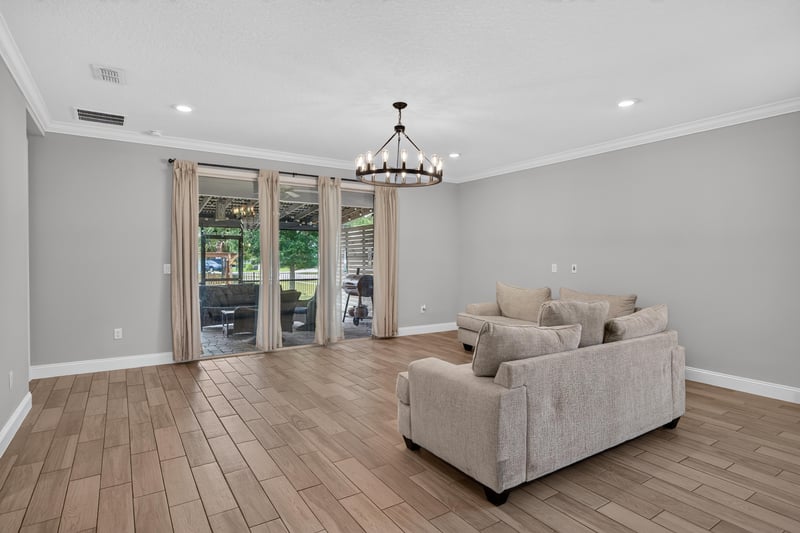 Living room with sliding glass doors to the back porch at 91 Tilloo Ct, St. Johns, FL