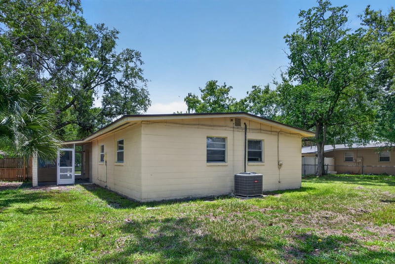 Rear exterior with covered porch and lawn at 5527 Beney Rd, Jacksonville, FL 32207