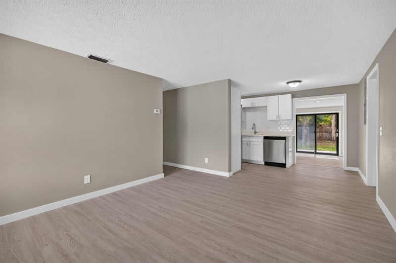 Empty room with window and view toward kitchen at 184 Draco St, Orange Park, FL 32073