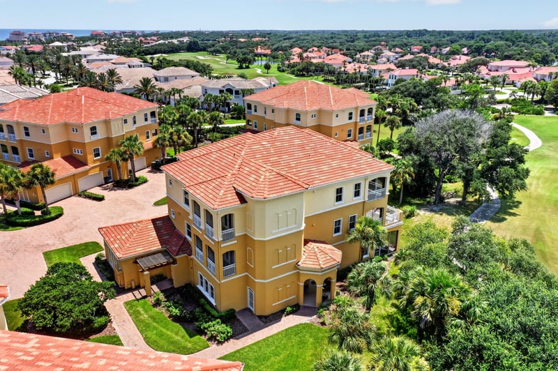 Aerial close-up of the tile-roof home and driveway at 140 Ave De La Mer, Palm Coast, FL 32137