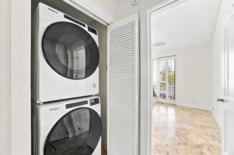 Stacked washer and dryer near hallway at 752 Spinnakers Reach Dr, Ponte Vedra Beach, FL 32082