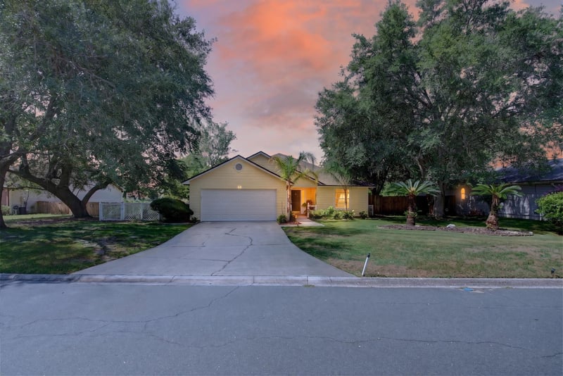 Day-to-dusk front exterior and driveway at 8680 Bandera Cir S, Jacksonville, FL 32244