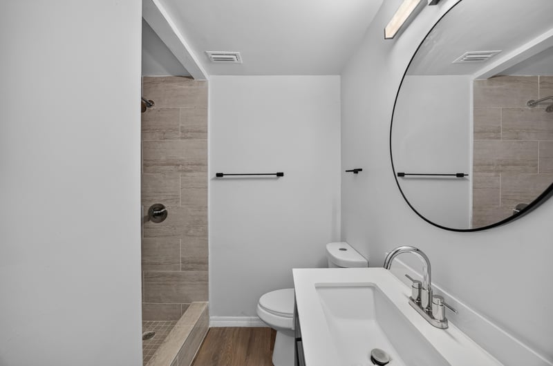 Bathroom vanity with mirror and shower at 4951 Halls Dr