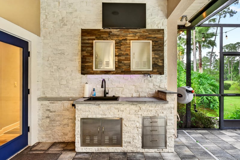 Outdoor kitchen with stone surround and grill at 2304 Spring Hill Ct, Orange Park, FL