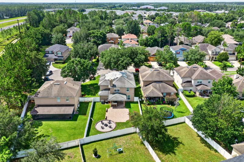 Aerial view of surrounding rooftops and trees in Orange Park, FL