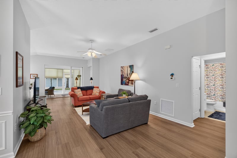 Living room with gray and orange sofas at 11225 Water Spring Cir, Jacksonville, FL 32256