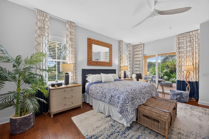 Bedroom with upholstered headboard and large windows at 140 Ave De La Mer, Palm Coast, FL 32137